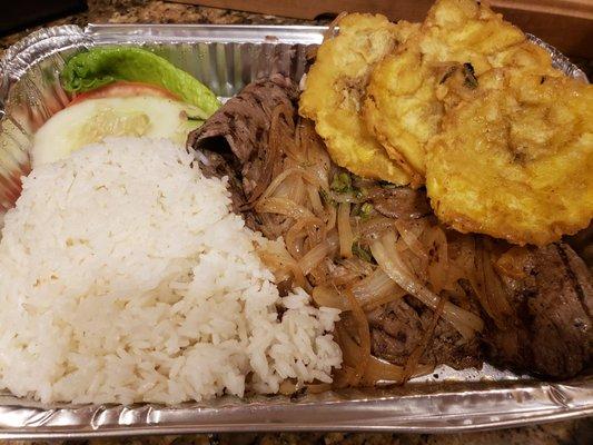 Bistek encebollado with arroz con frijoles (not pictured), huge tostones and Mini salad.