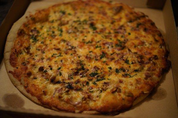 A delicious cauliflower, pistachio, onion, Montalban cheese pizza. Bought parbaked and baked at home.