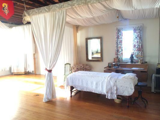 Curtains are drawn around the table area during massage work. It is awarm restful sanctuary!