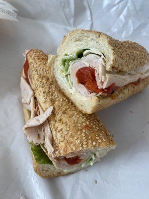 Turkey with sharp provolone and roasted red peppers on a seeded roll