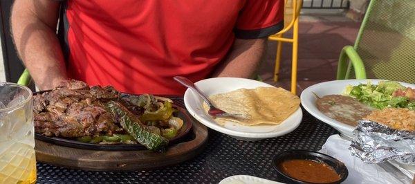 Carne asada with corn tortillas, refried beans and Mexican rice