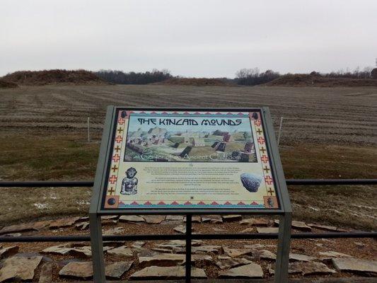 One of the plaques with mounds in the background