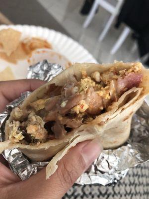 Inside. Bacon and sausage. They include beans in the breakfast burrito which is AWESOME! Yum!