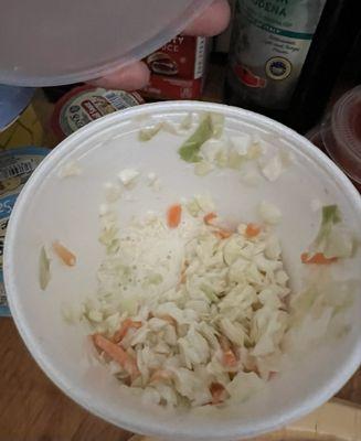 This is a pre-eaten cup of cole slaw.