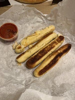 Burnt and broken breadsticks that she said were totally fine.