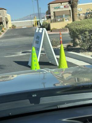 Sign and cones to explain the waiting line goes along the east property line by the vacant lot.