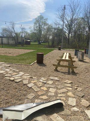 Evolving patio area surrounding the sand court