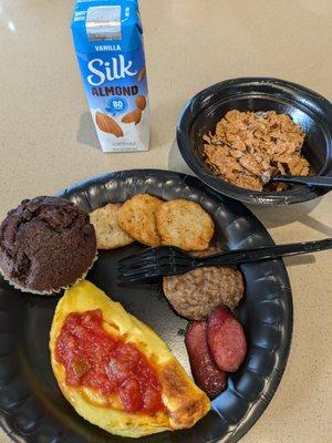 Cheese omelet w/ salsa I added, rope sausage, pattie sausage, hash browns, chocolate muffin,  Almond milk & cereal in the back