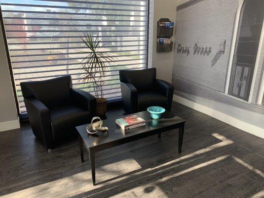 Client waiting area with comfy chairs and magazines