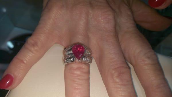 My original wedding ring.  I took out original diamond & replaced with a pear shaped ruby  encased in a halo of diamonds.