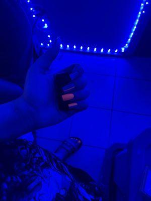 a picture of nails glowing with a blue light