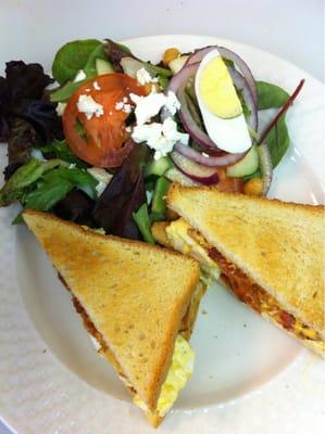 Egg salad, bacon,tomato, russian dressing, on white toast  with salad on the side