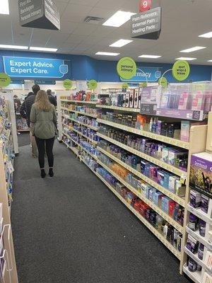 The line for the pharmacy extending past the personal intimacy aisle