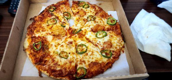 Whole wheat crust pizza with jalapenos, regular cheese