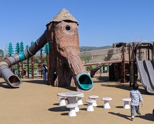 Treehouse slide, you can't see the kids but you will hear them bottlenecking inside.