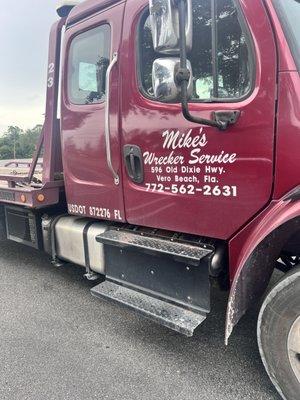 Tow truck with logo and contact info