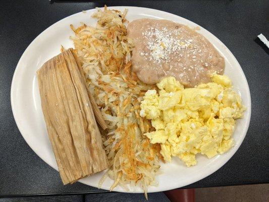 Red tamale, hash browns, eggs, beans