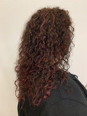 Pink highlights with natural wavy hair