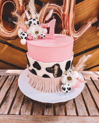 Cowgirl theme cake. The front black spot is a reflection not smeared.