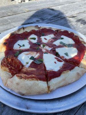 Margarita pizza. With little tiny scraps of basil.