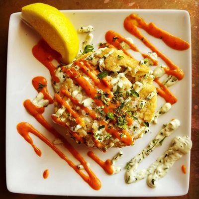 Jumbo Crab Cake with corn tortilla crust. Chile aoili & cilantro crema. Superb gluten-free appetizer!