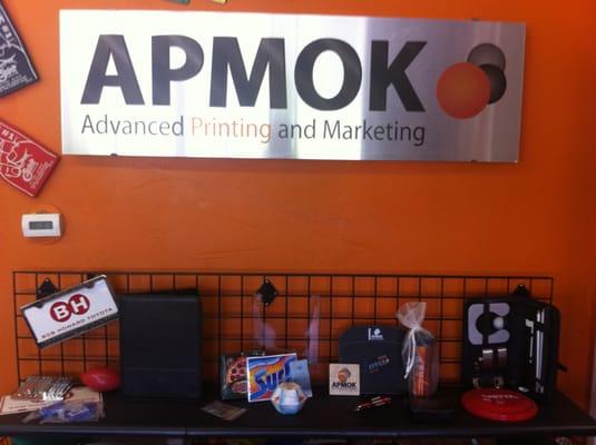 The sign was printed on die bond, and below it our some of our promotional items.