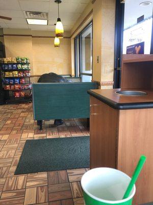 Man sleeping on table inside of subway