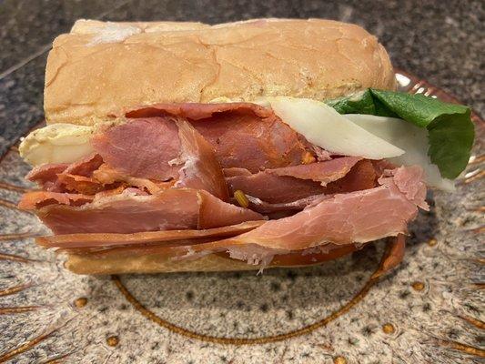 Half of The Brooklyn on an Italian hoagie with lettuce, onion, mayo, spicy mustard, vinegar, salt and pepper.