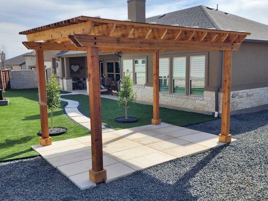 Artificial turf, walkway, pergola, and patio.