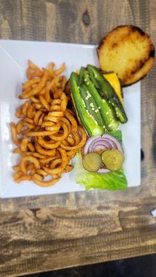 Japeno burger topped with american cheese and fries.