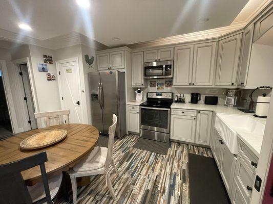 Kitchen area. Kitchen was fully stocked. Washer, dryer, and bathroom located to the left. Entrance to cottage on the right.