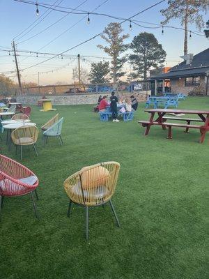 The yard area with picnic tables and bags stations.