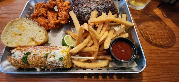 Nashville Hot chicken strips, half rack of baby back ribs, street corn, and fries