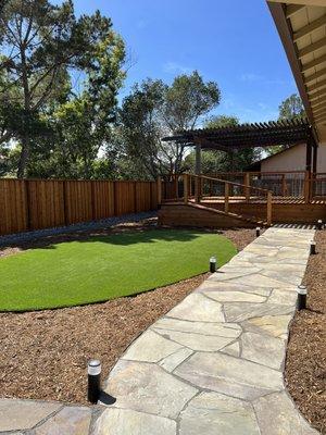 New bluestone, landscape, lighting, turf, redwood fence & deck.