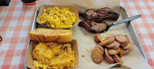 Brisket, jalapeno sausage, spoon bread, and green chili mac and cheese