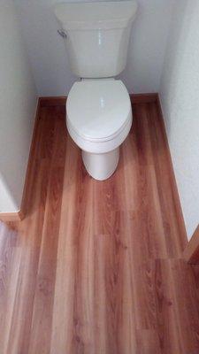 Custom flooring and trim work topped off with a new toilet installation