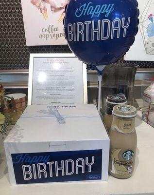 Birthday packaging of a dozen cookies, 2 Starbucks Frappuccino & a birthday balloon.