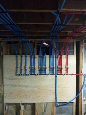 Example of a pex tubing manifold system. A great way to isolate each fixture in your home with a shutoff valve on each line.