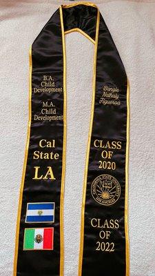 Sash embroidered with name, degree, + flags.