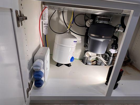 Full install of water filtration system, garbage disposer, faucets, air switch, and soap dispenser.