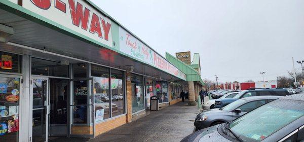 The pizza shop is located in the strip mall