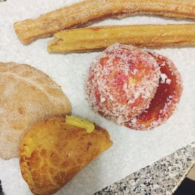 (Left) cream empanadas and pecan empanadas. Churros on top. Yoyo de fresas to the middle.