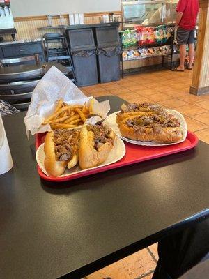 Two cheesesteaks and french fries. Yummy