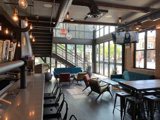 Downstairs, window seating with couches and armchairs.