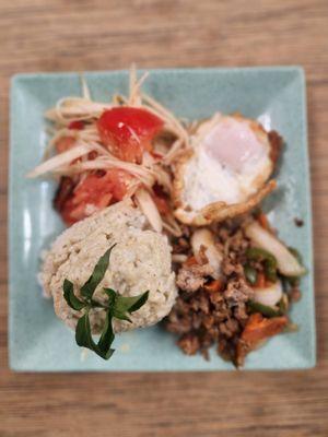 Locomotives plate with rice, curry paste, meat,salad and fried egg