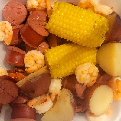 Low country boil. Garlic butter, seasoning and hot sauce ordered on the side for that personal touch.