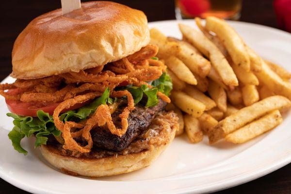 Our Draft Day Burger features cheddar, fried onion strings, bacon jam, lettuce and tomato.