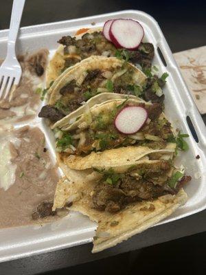 Tacos de tripa & tacos de asada con rice(under the tacos) and beans. ‍