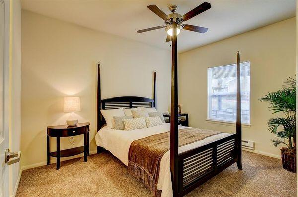 Classic bedroom - ceiling fans to keep you cool and windows to let in some great natural light.