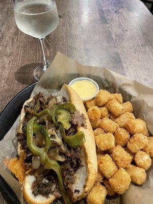 Philly Cheesesteak Tater tots Cheese sauce Pinot girio